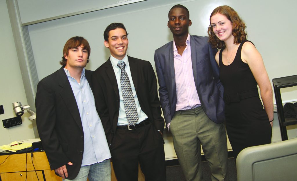 The two debate teams posing for the camera.