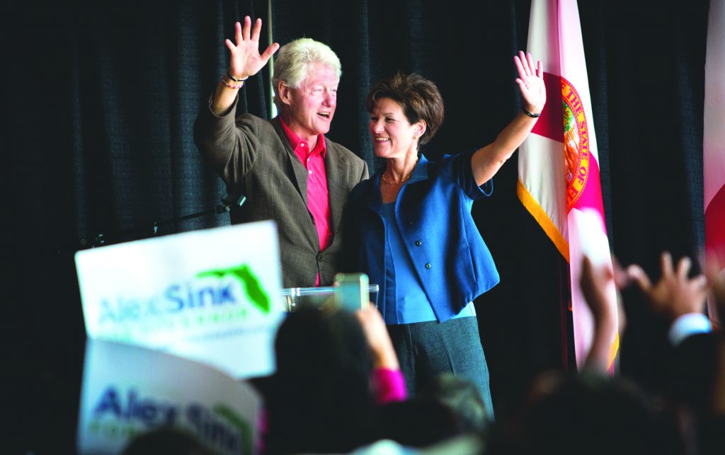 Bill Clinton and Alex Sink waving at the students.