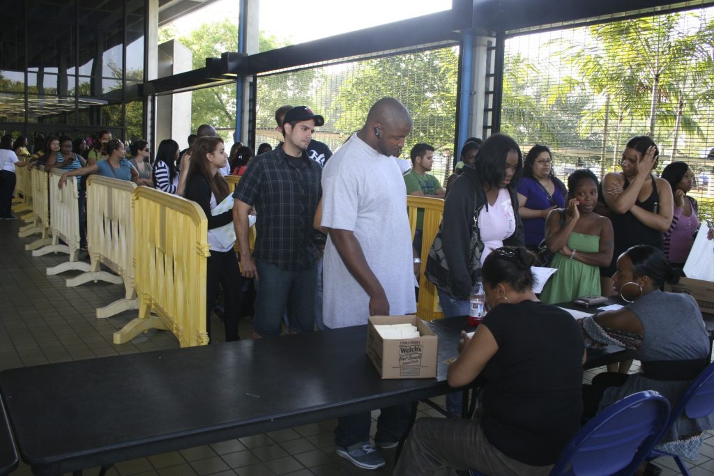 Students getting their cap and gown for graduation.