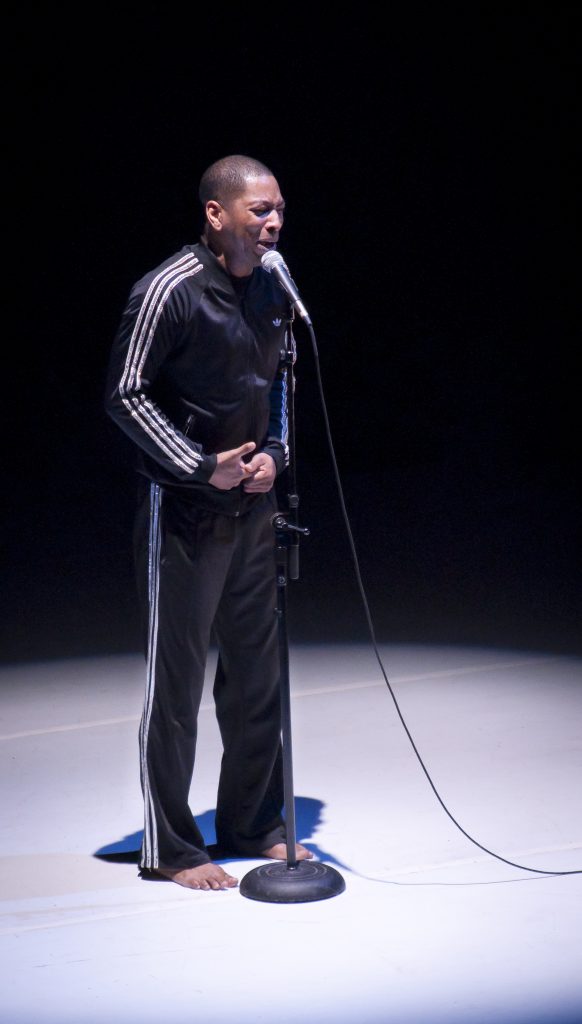 Performer singing on stage.