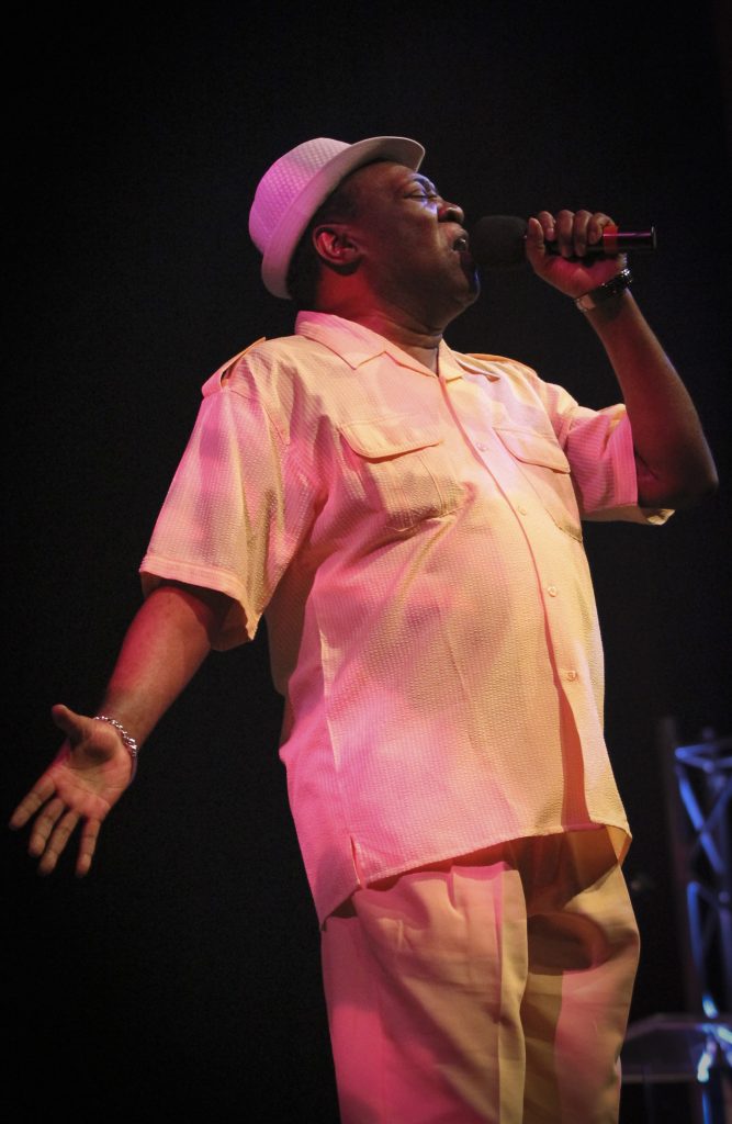 Singer performing on stage.