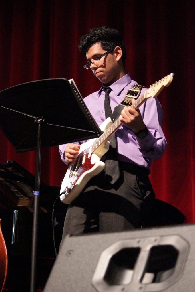 Student playing his guitar at North Campus.