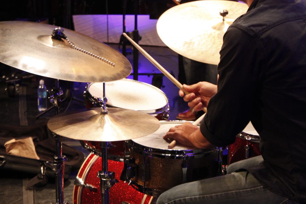 Faculty professor playing the drums.