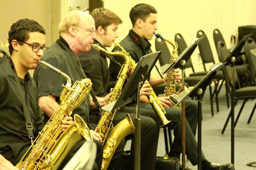 Students performing with their music instruments.