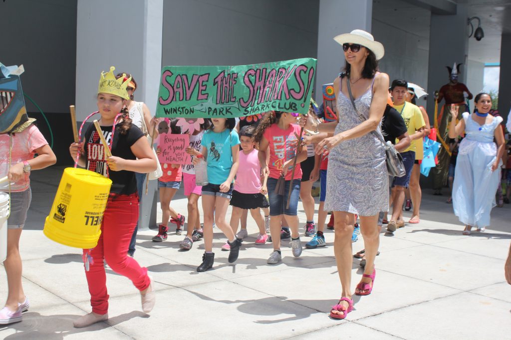 A group of children parading down with a 