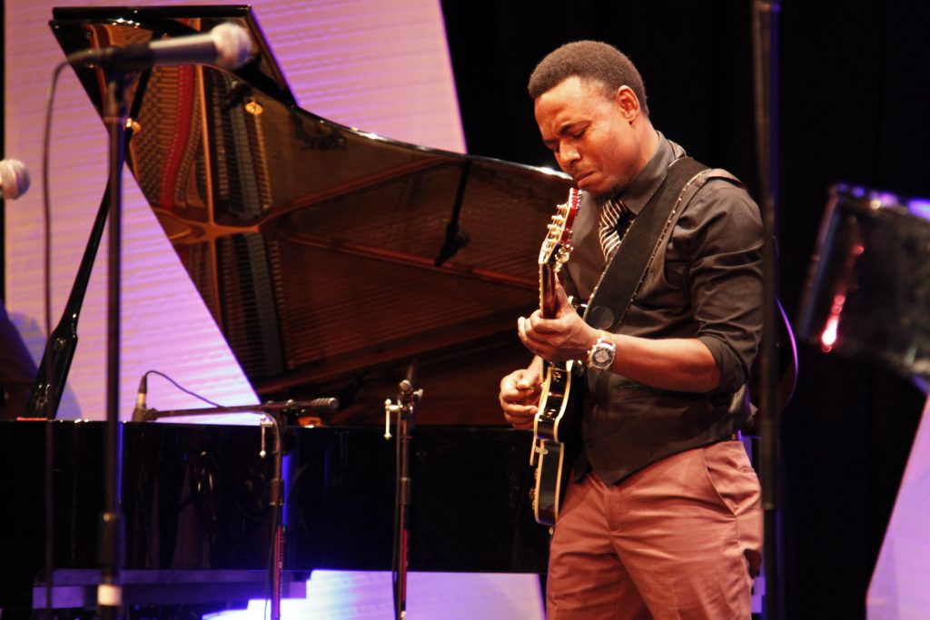 Music student playing guitar at Wolfson Campus.