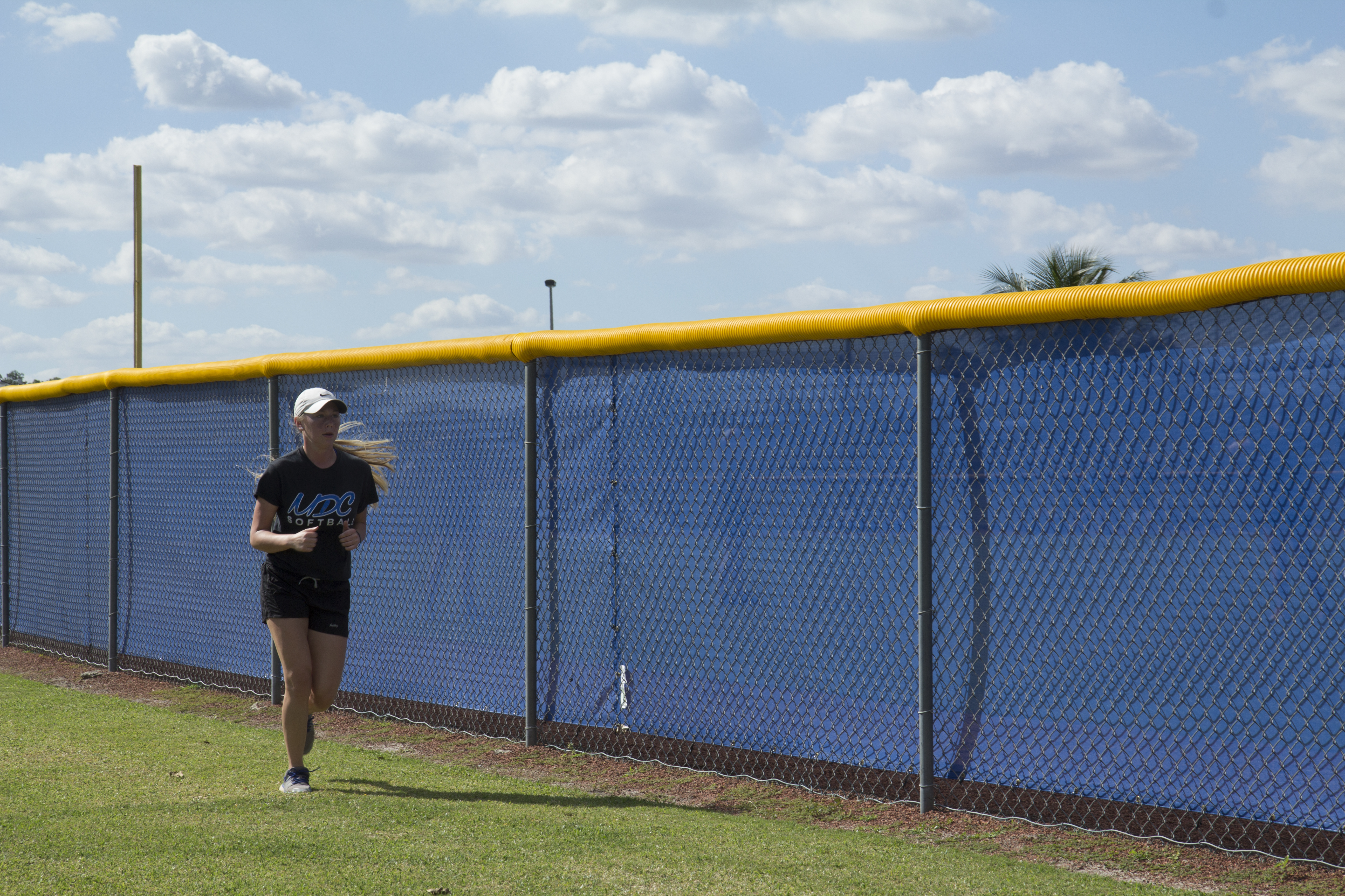 Cortney Bunker running in the filed.