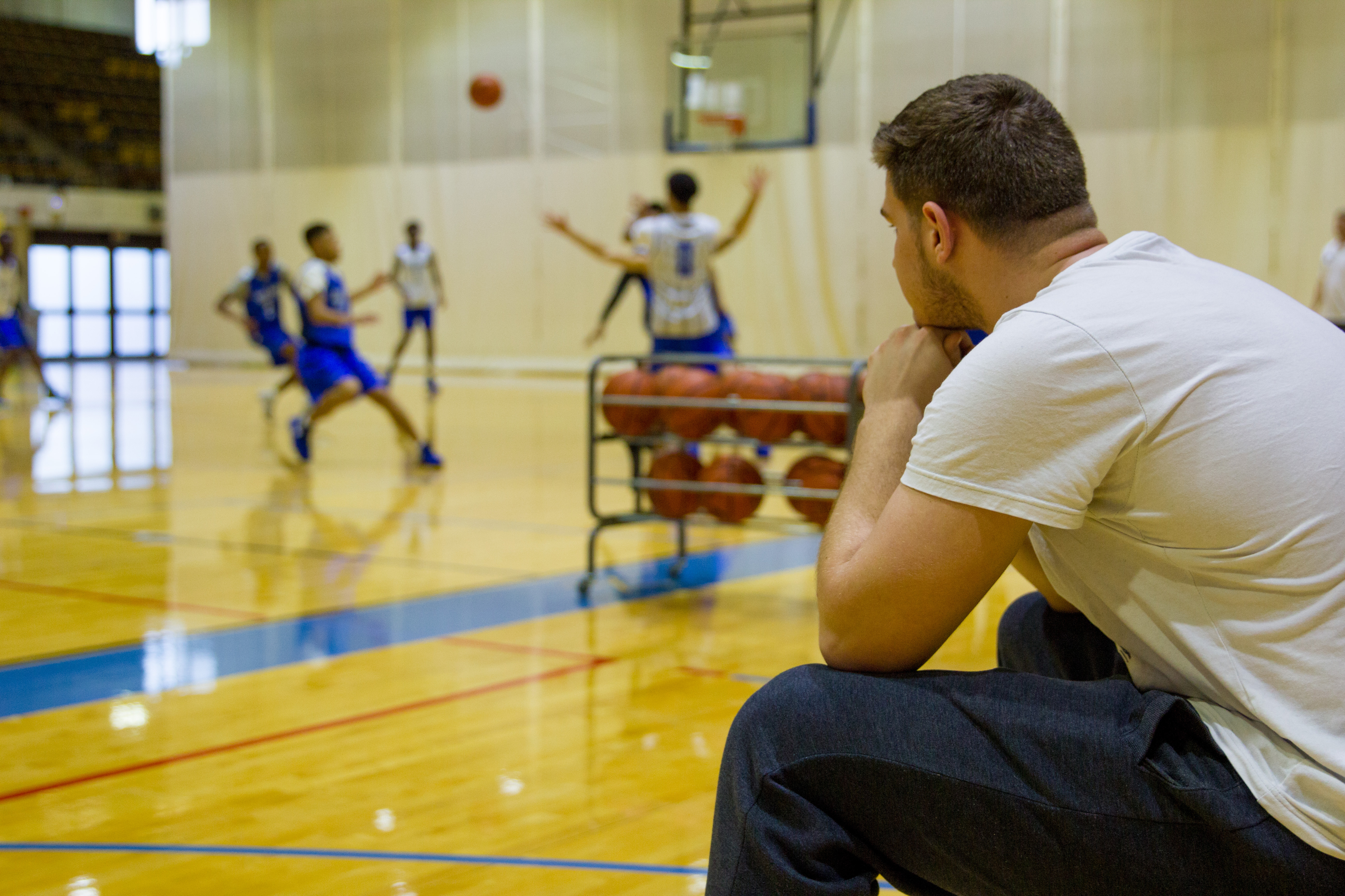 Karol Kott sitting watching his teammates during practice.
