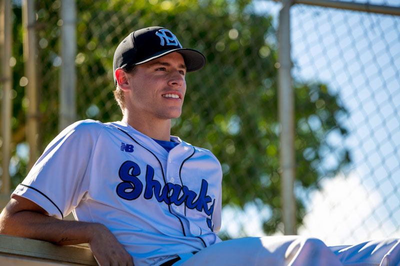Garrett Bye sitting on the bleachers.