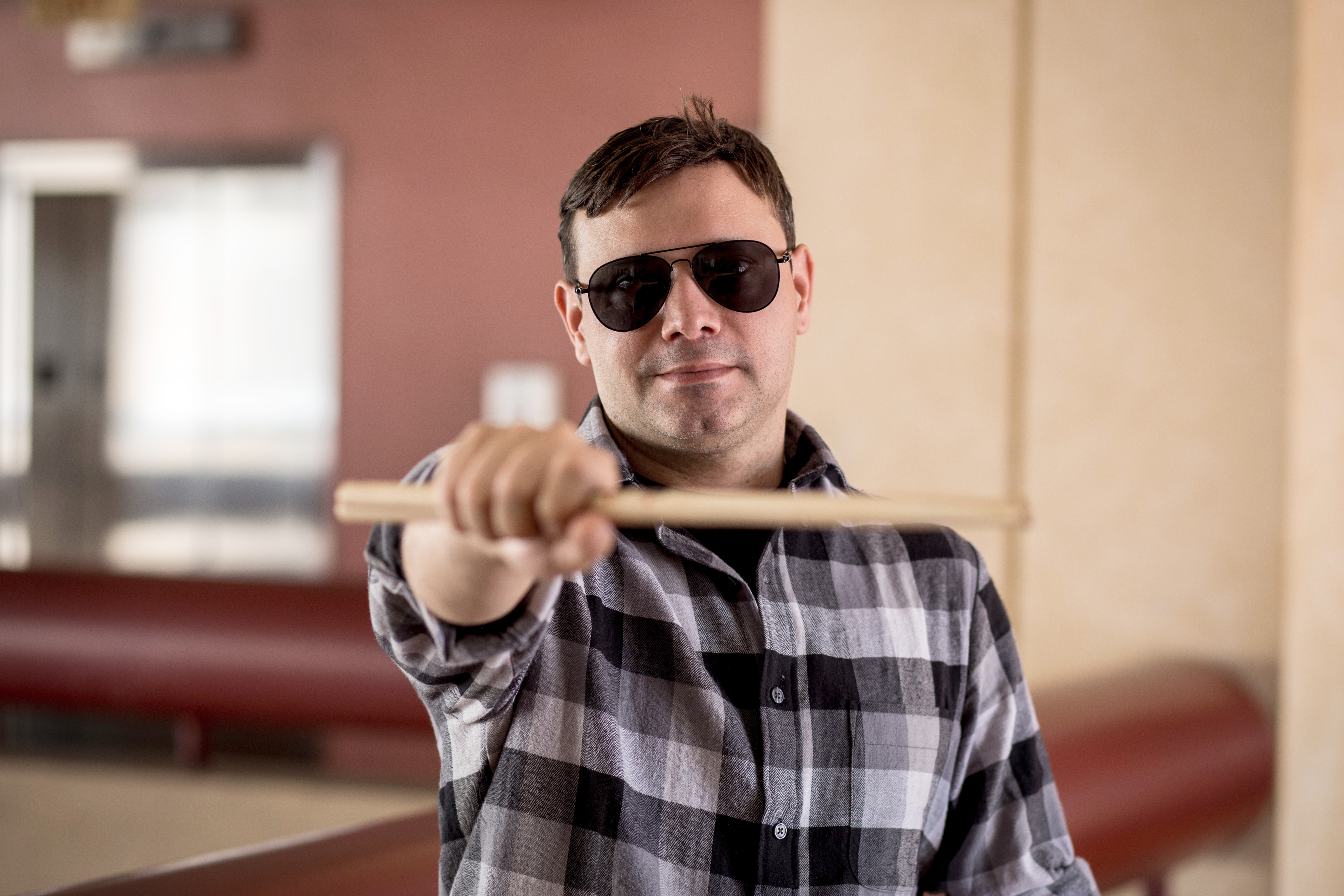 Humberto Molero posing for the camera with his drumsticks.