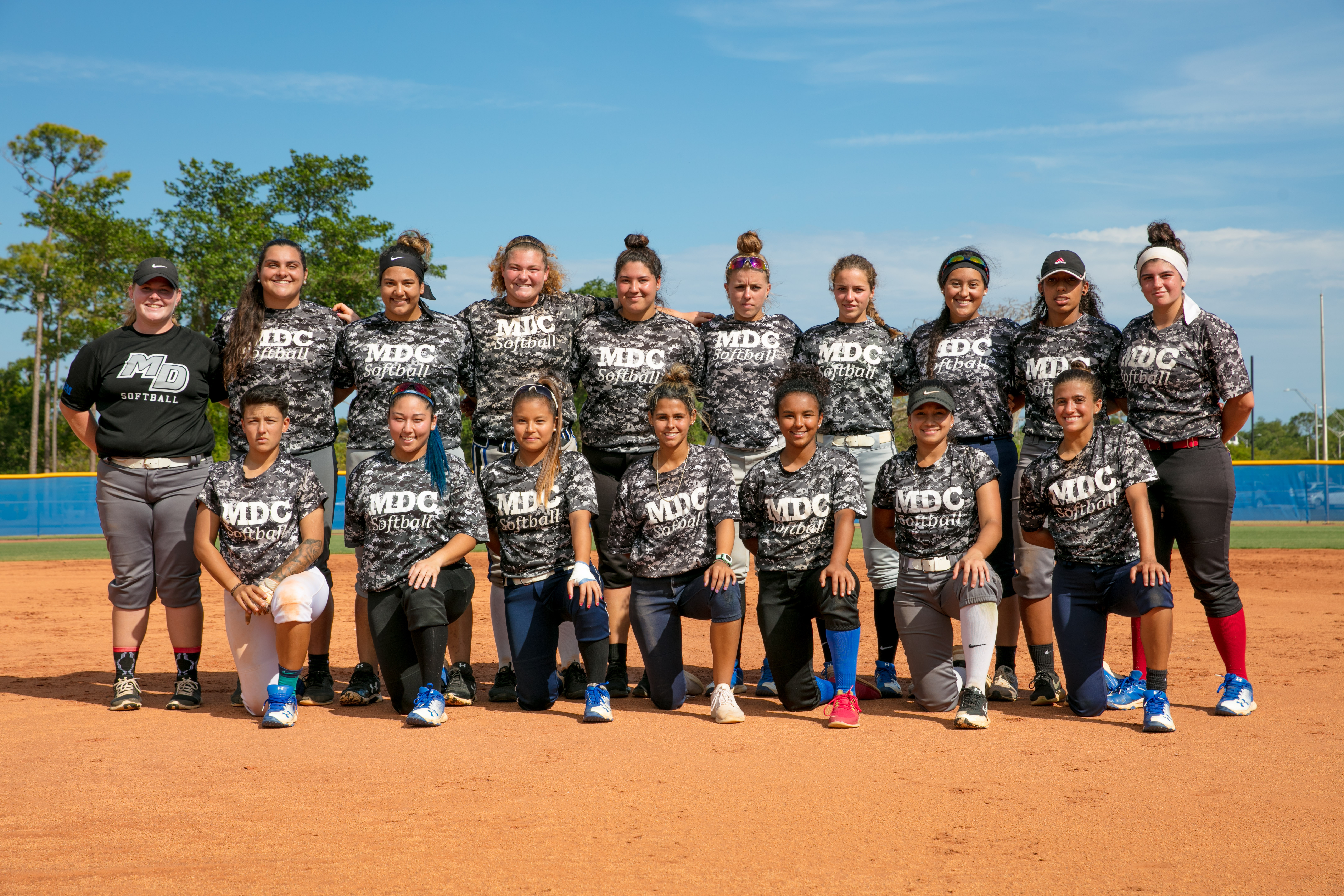 The softball team posing for a picture.
