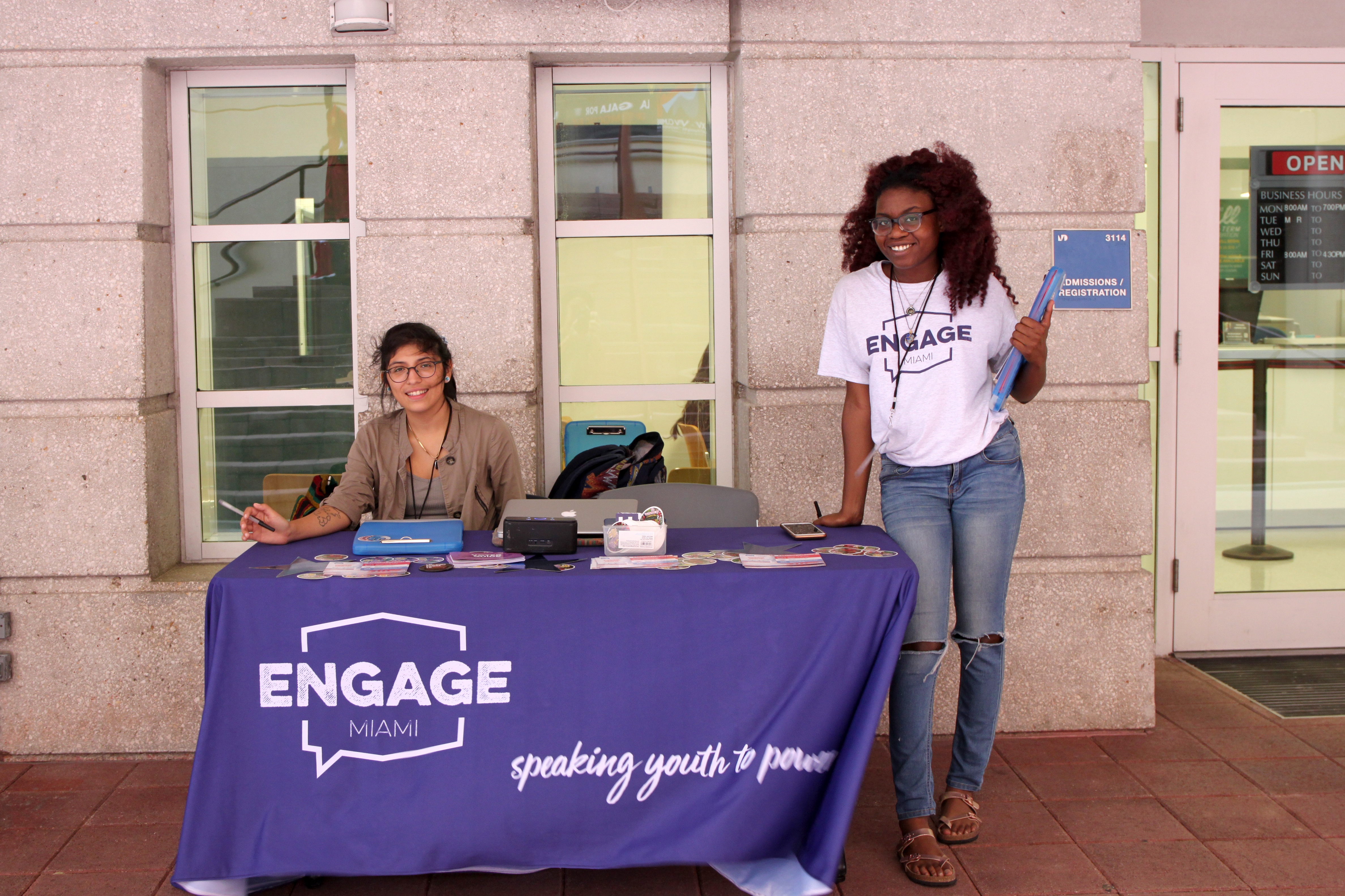 Two volunteers at the table waiting to help students.