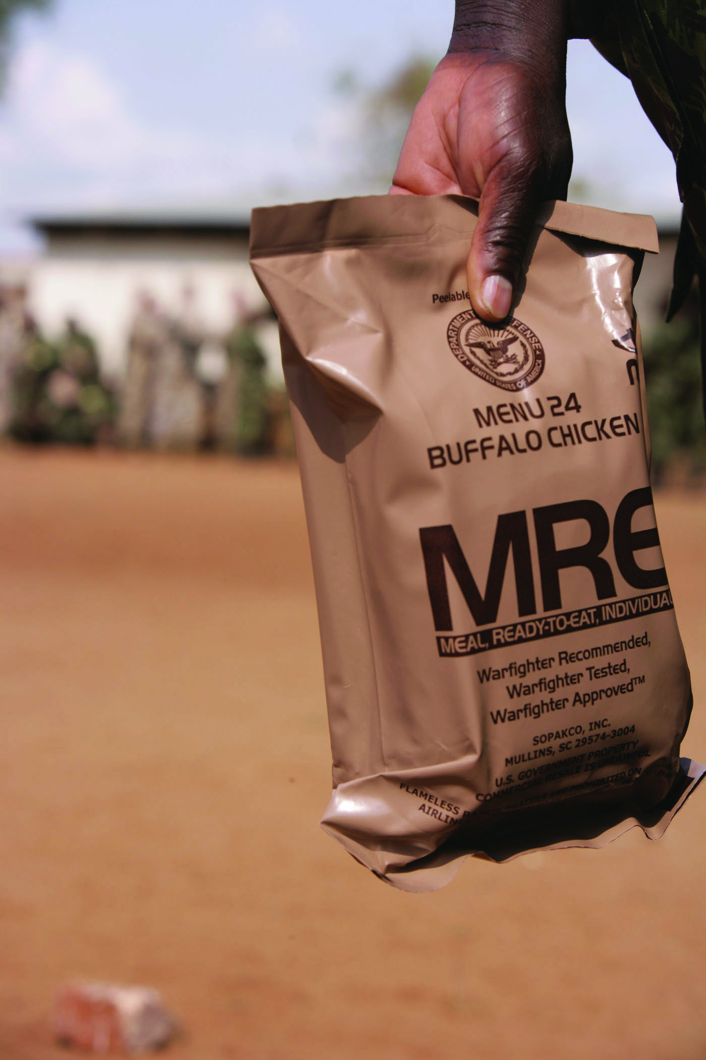 A soldier holding one of many rations of MRE.