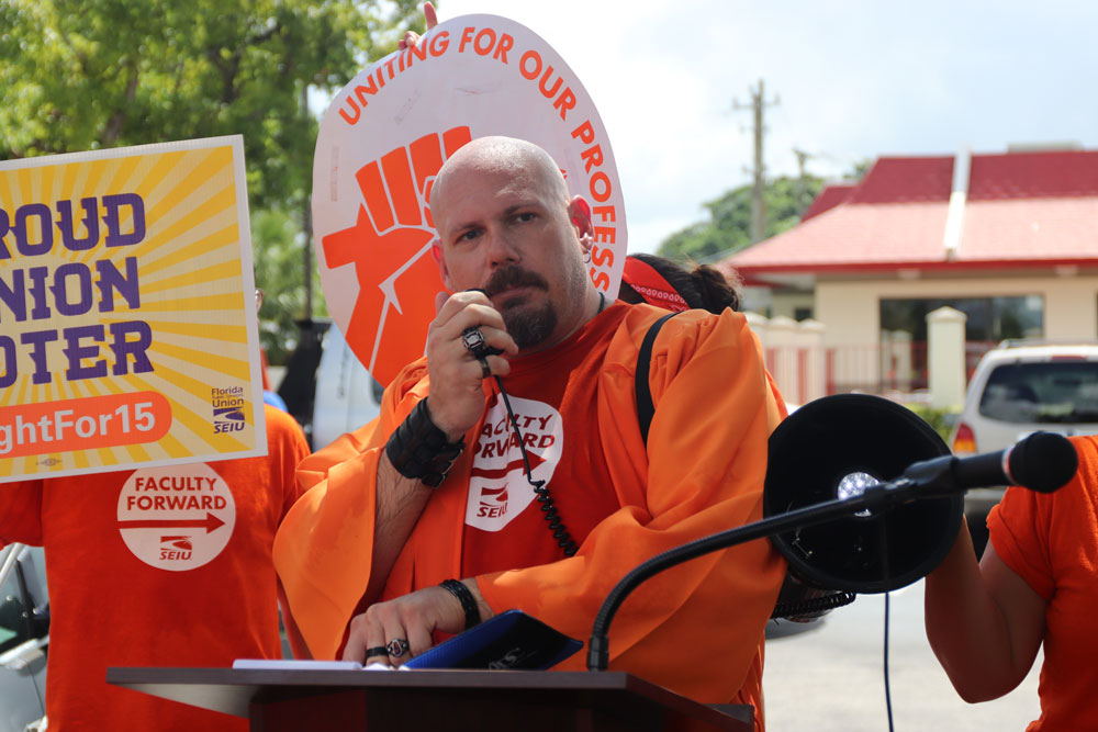 A professor giving a speech at a rally.