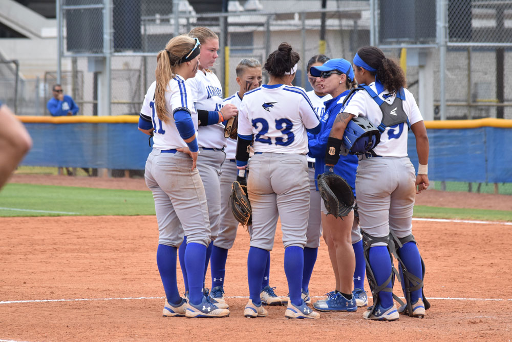 The Lady Sharks huddled with the coach.