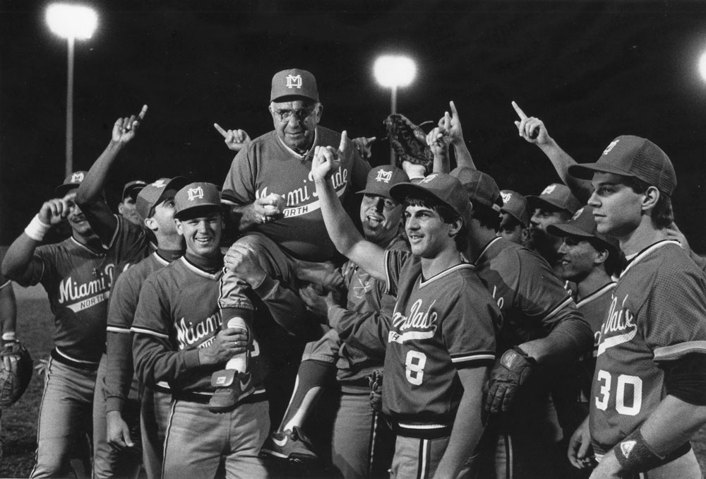 MDC baseball players carrying Demie Mainieri.