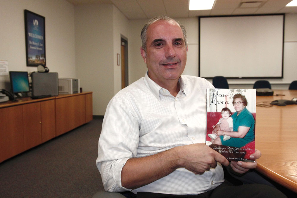 Shawn Schwaner posing with his book.