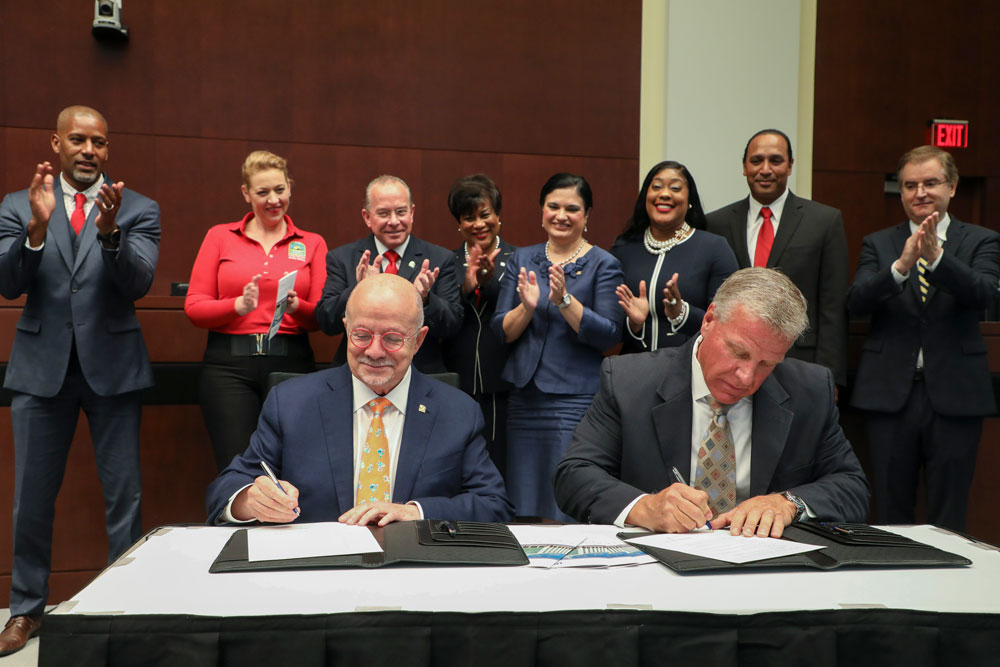 President Padron and Homestead Major Jon Burgess signing papers.