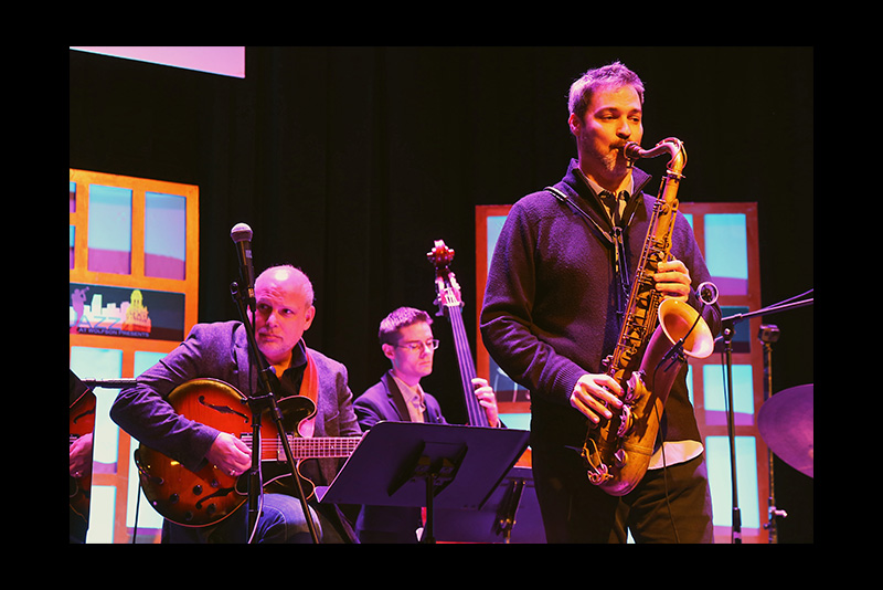 Jazz musician performing on stage.