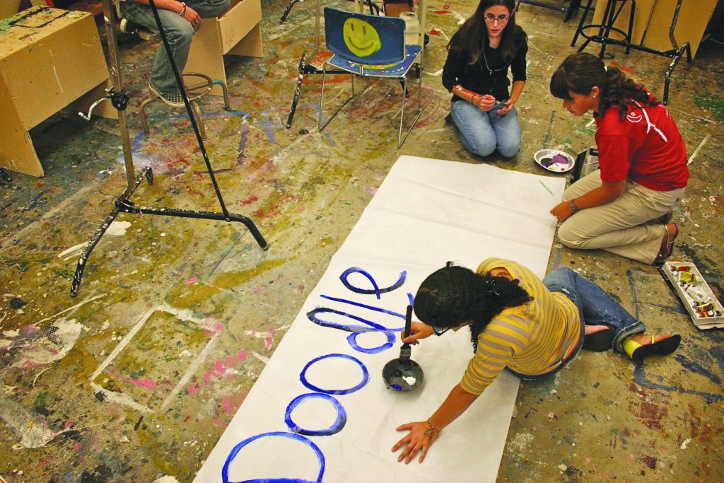 Student preparing a banner.