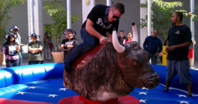 Student riding a mechanical bull.