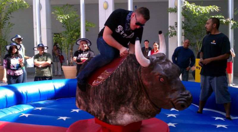Student riding a mechanical bull.
