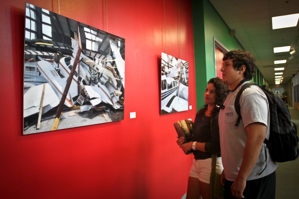 Two students looking at artwork.