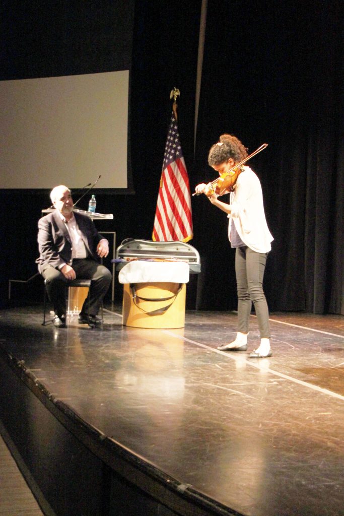 A New World School of the Arts student playing her violin on stage.