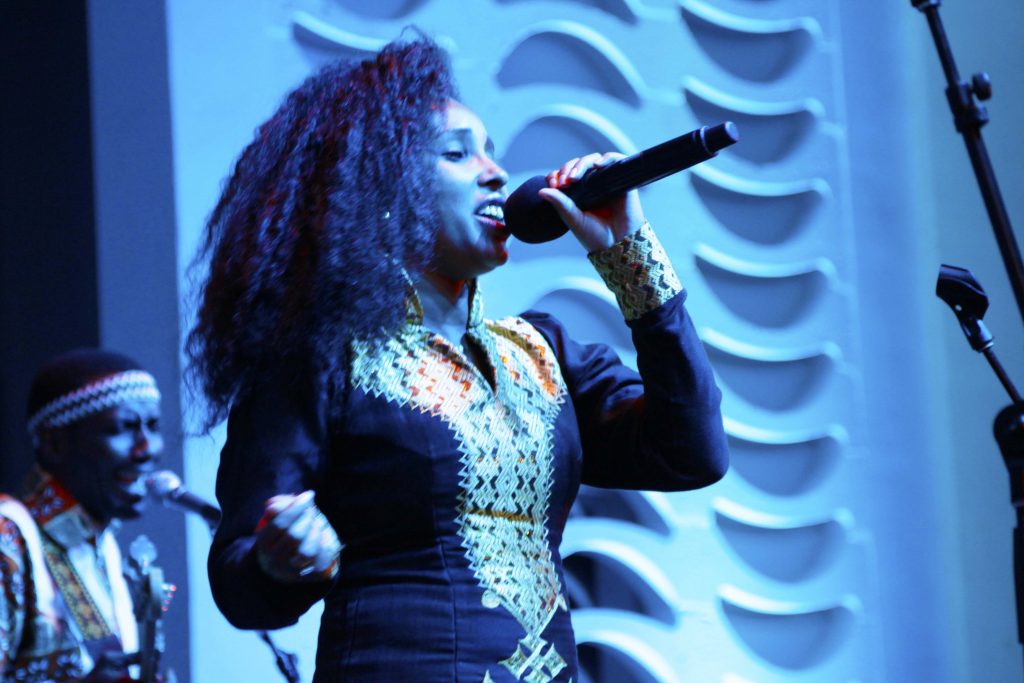 Singer performing on stage.