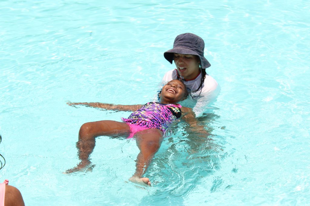 Aracely Lopez teaching a little girl how to swim.