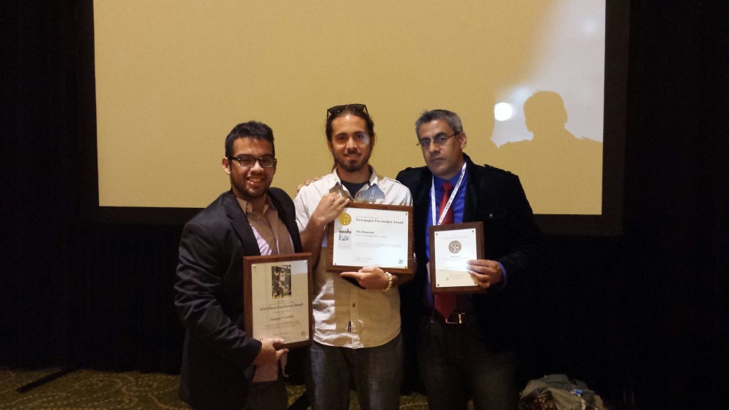 Gregory Castillo, Mark Pulaski and Manolo Barco holding the awards won by The Reporter.