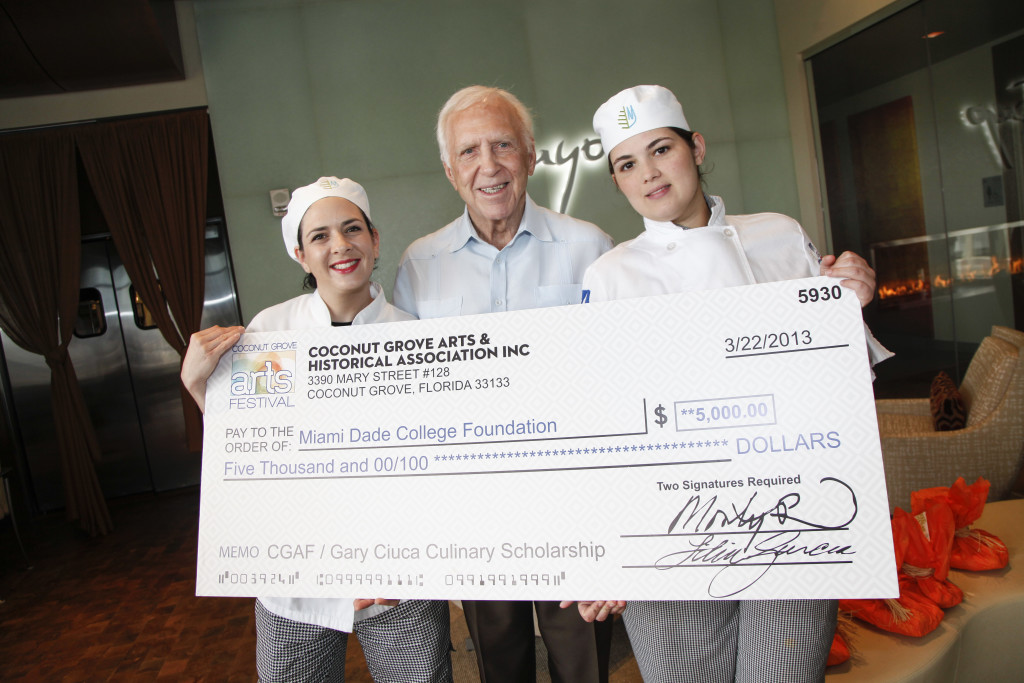 Photo of students holding scholarship check.