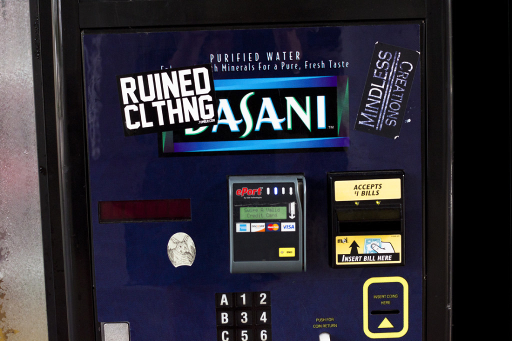 Image of sticker vandalism on vending machine.