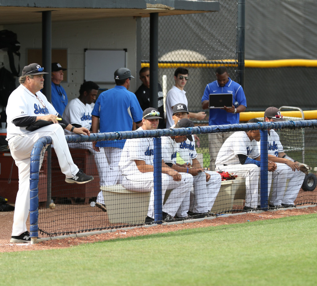 Coach Price along with some players watching a game.