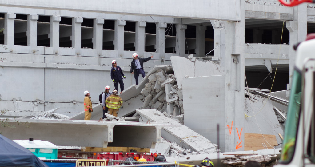 Rescue workers searching the rubble for trapped construction workers.