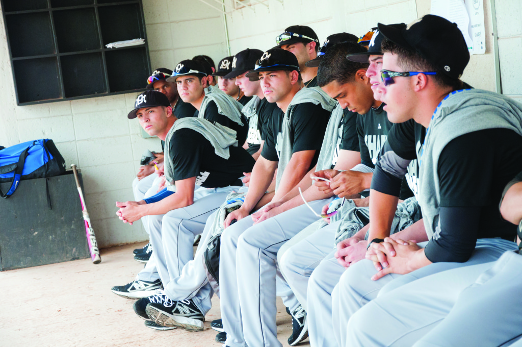 The MDC baseball team sitting on the bench.