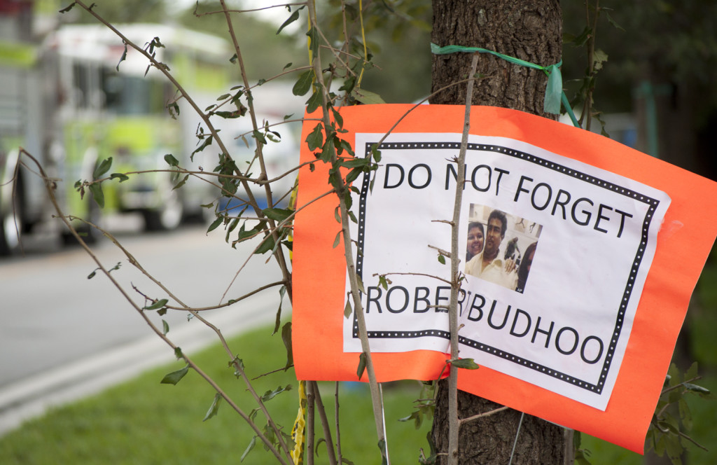 A sign from the Budhoo family stating "Do Not Forget Robert Budhoo."