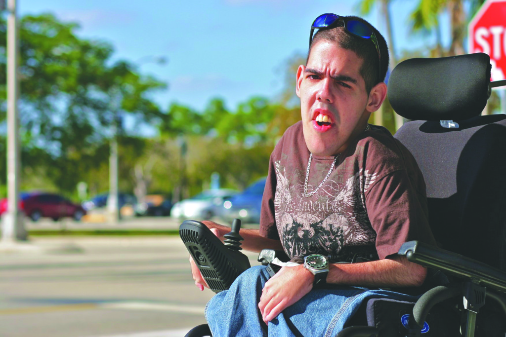 Luis Vazquez sitting outside on his wheelchair.