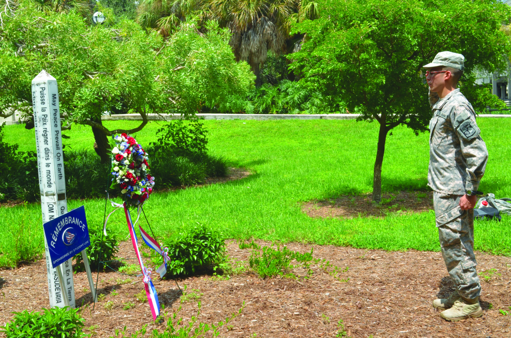 Cadet Andres Merchan saluting the 9/11 memorial at Miami Dade College Kendall Campus.