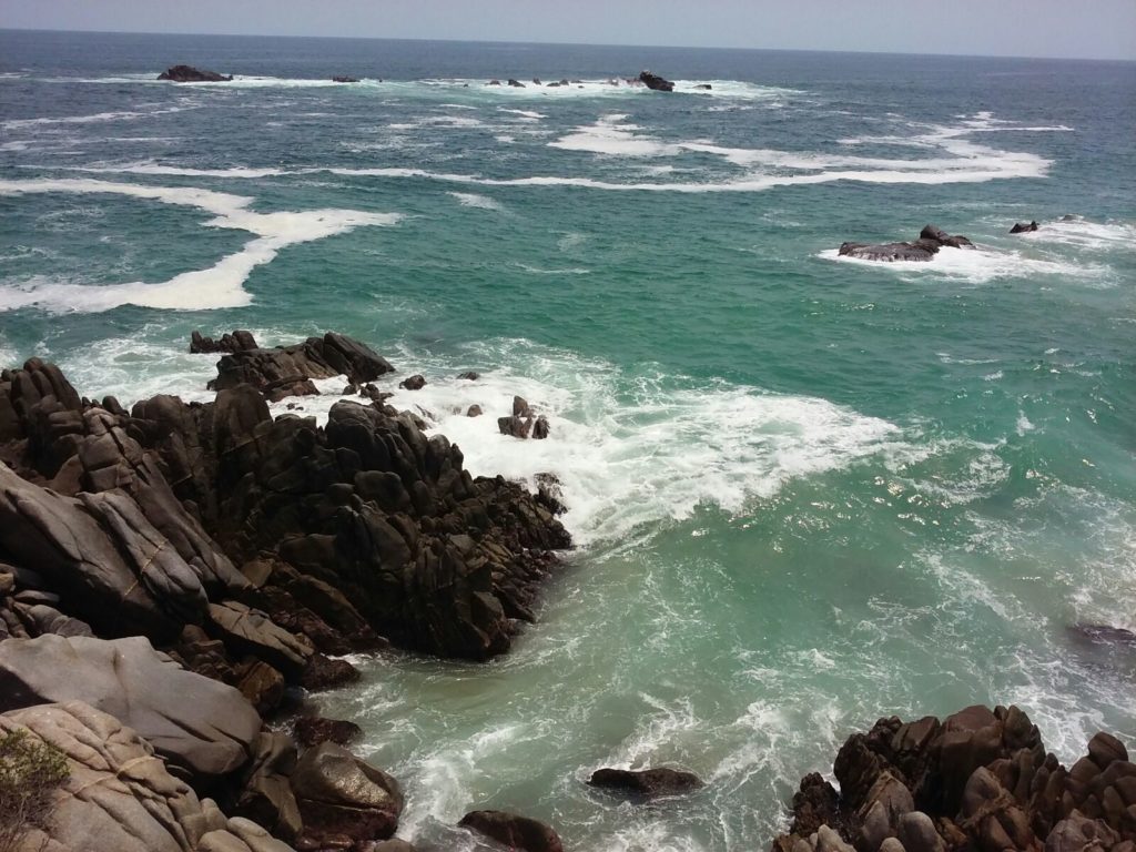 Waves crashing into rocks on Boca Vieja Beach, Mexico.