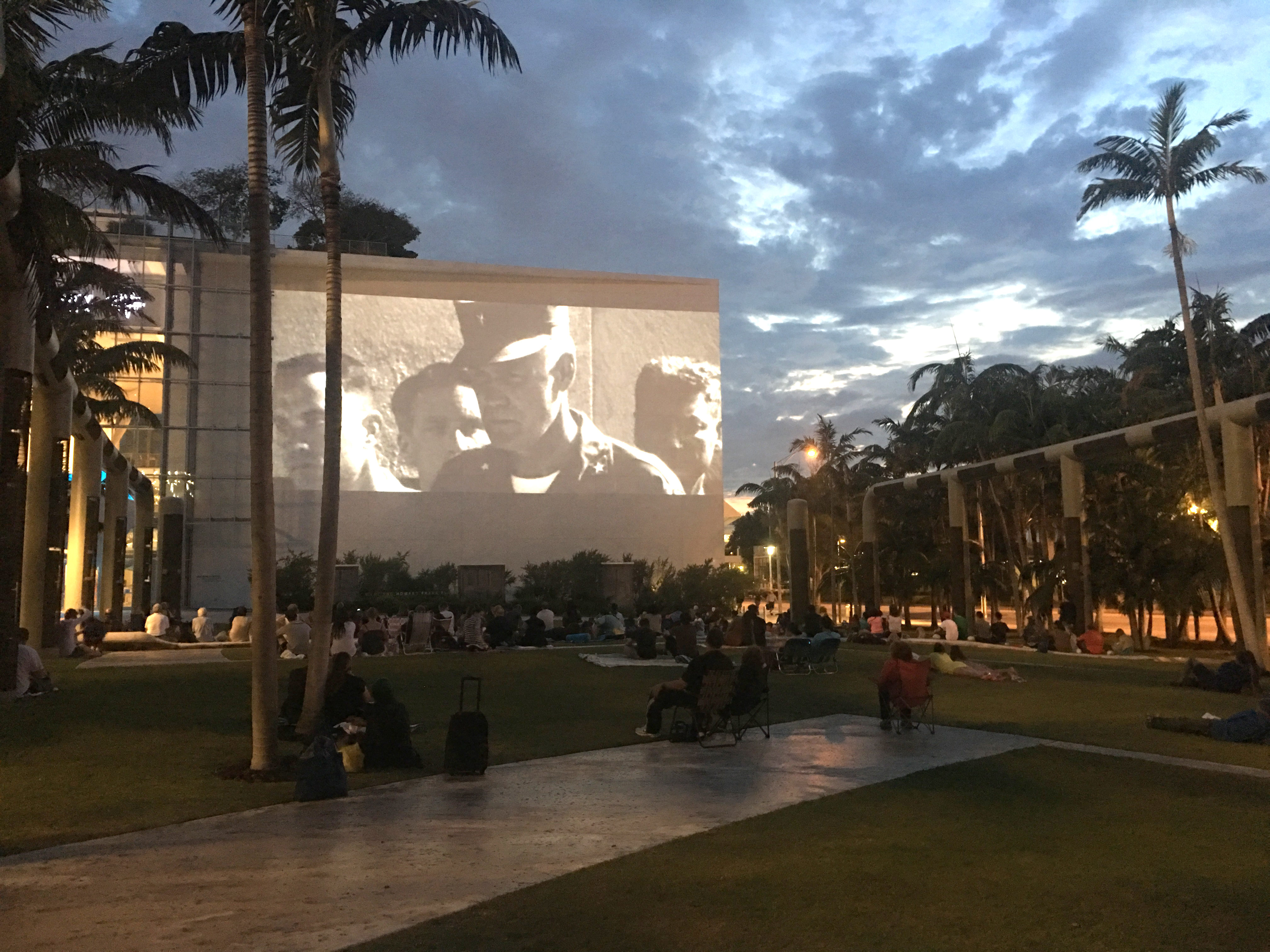 An audience outside New World Center watching a movie as part of the Miami Beach Soundscape Cinema Series.