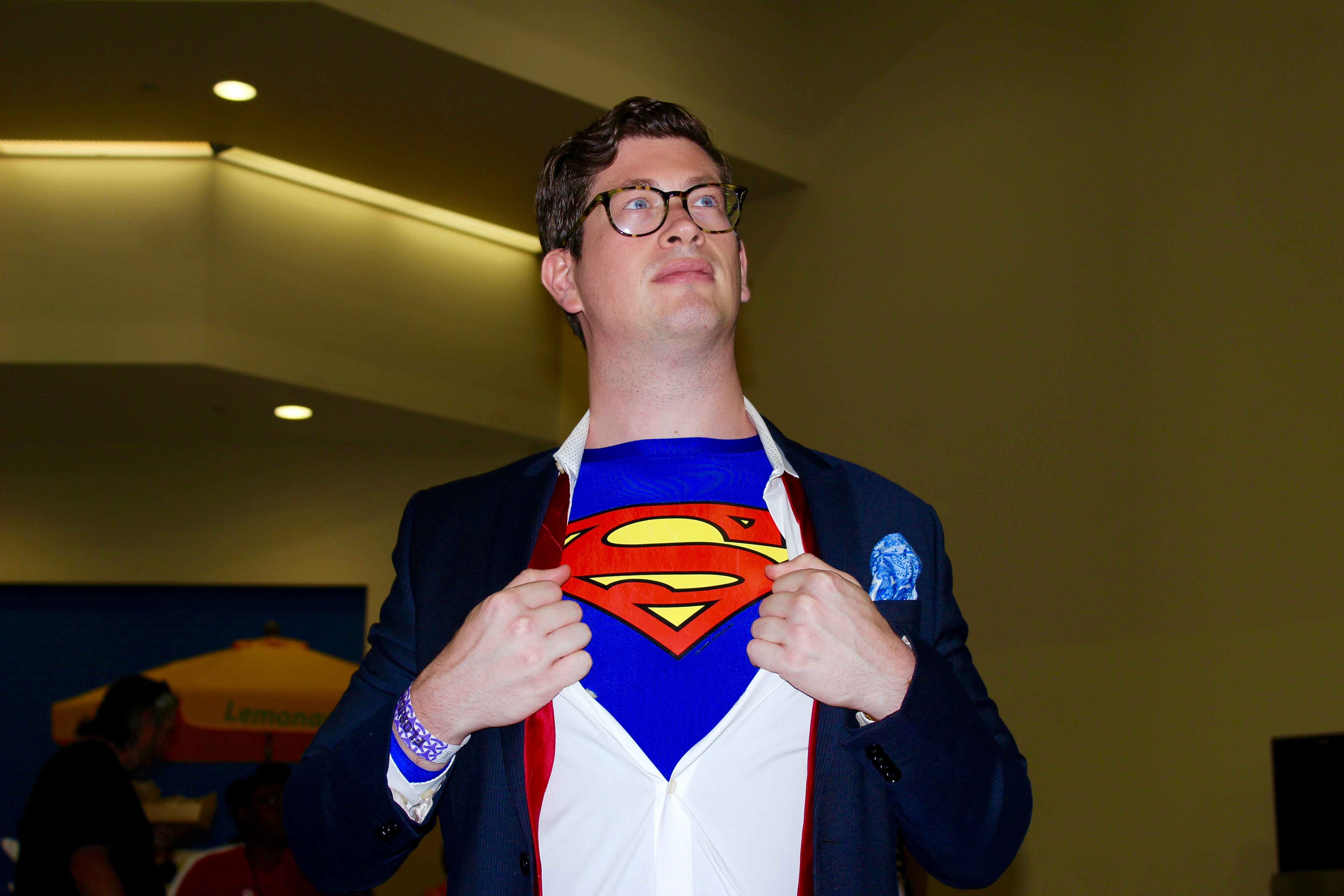 A cosplayer dressed as Clark Kent/Superman.