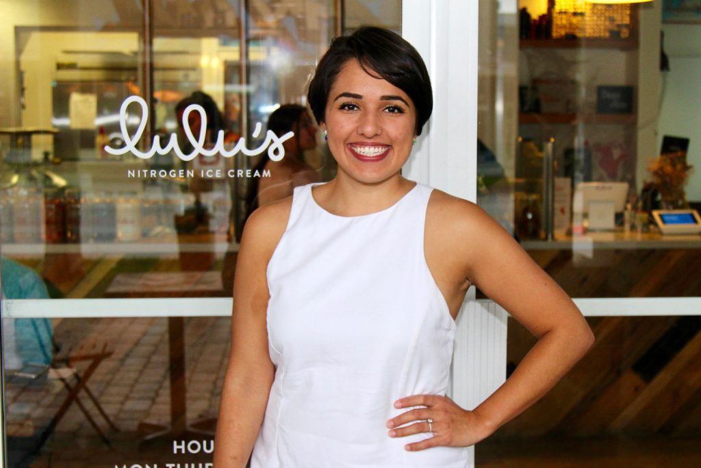 Luisa Santos posing in front of her ice cream shop.