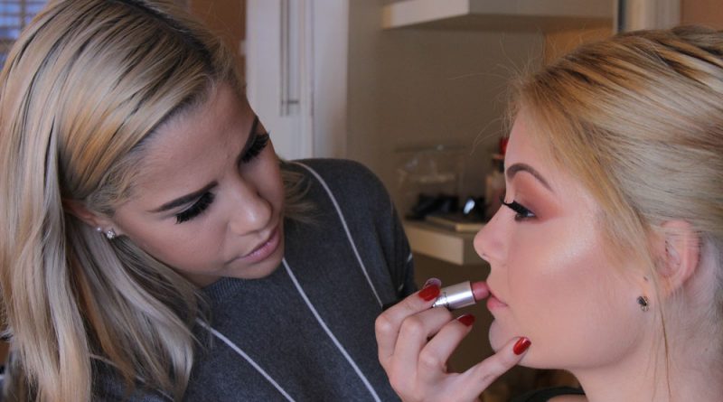 Sophia Marie Perez applying lipstick to her best friend Alondra Pedroso.