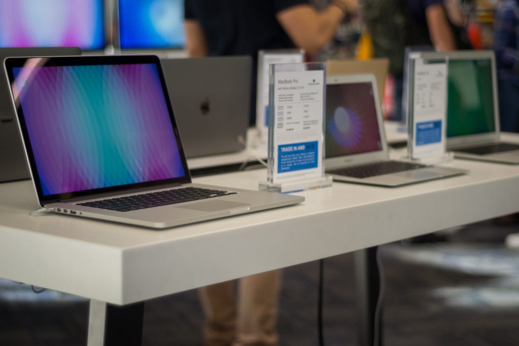 Several Apple laptops on display.