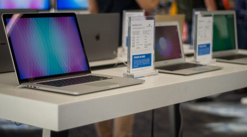 Several Apple laptops on display.