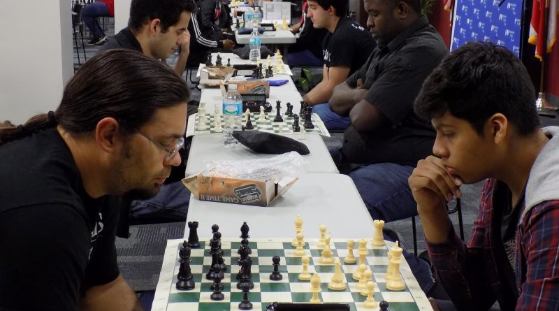 Students playing chess at the chess tournament.