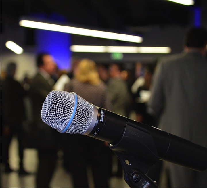 The Idea Center celebrating its grand opening. A microphone in the foreground.