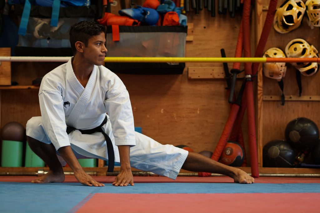 David Bavaresco stretching at a dojo.