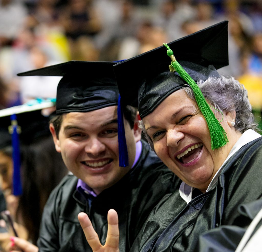 Mother and son graduating together at commencement.